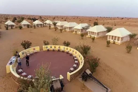The camp from above, tents set in a ring around an open stage