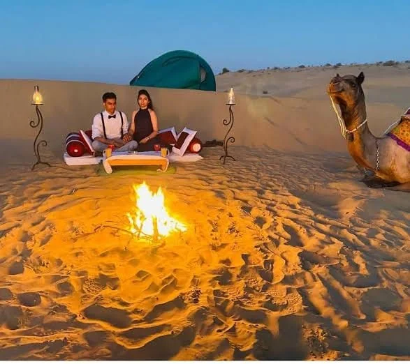 Candlelit dinner and a bonfire on the dune at dusk